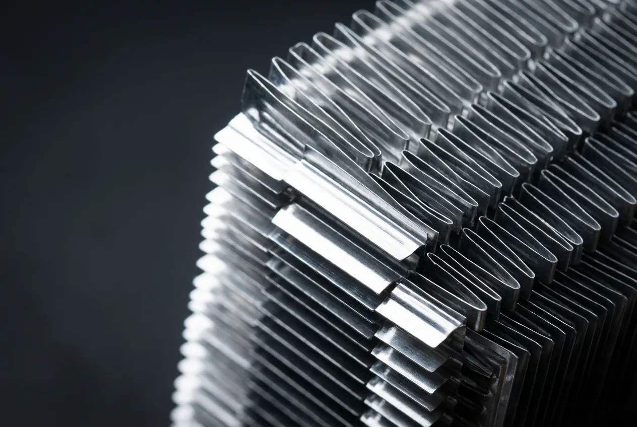 Condenseur Clim Clio 3 : Guide Complet (Symptômes, Prix) Gros plan macro sur les ailettes d'un condenseur de climatisation neuf pour Clio 3, sur fond neutre.